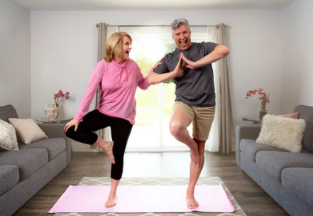 couple practicing balance training in living room