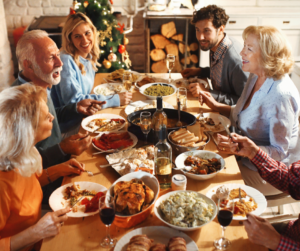 Family Thanksgiving at table with large dinner spread