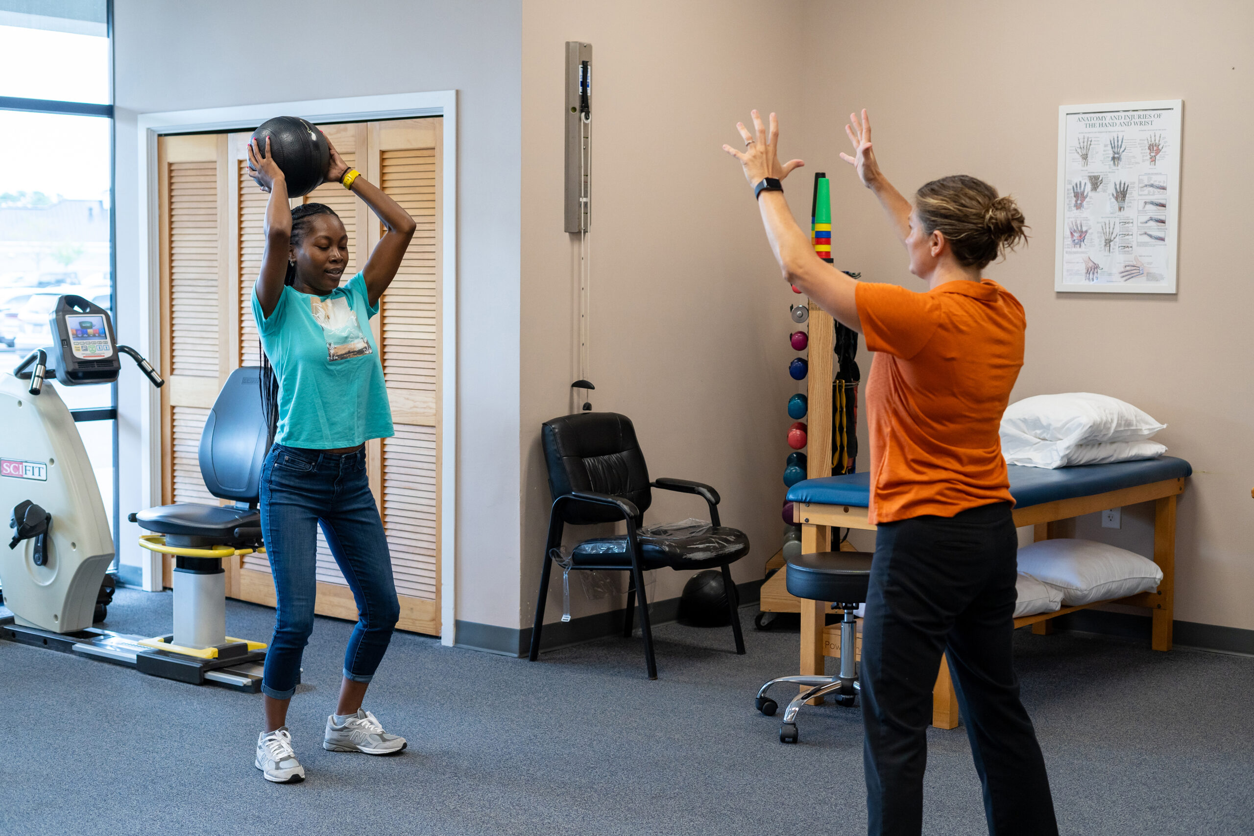 two people in a room with exercise equipment