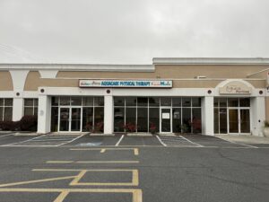 the front of a building with a parking lot in front of it