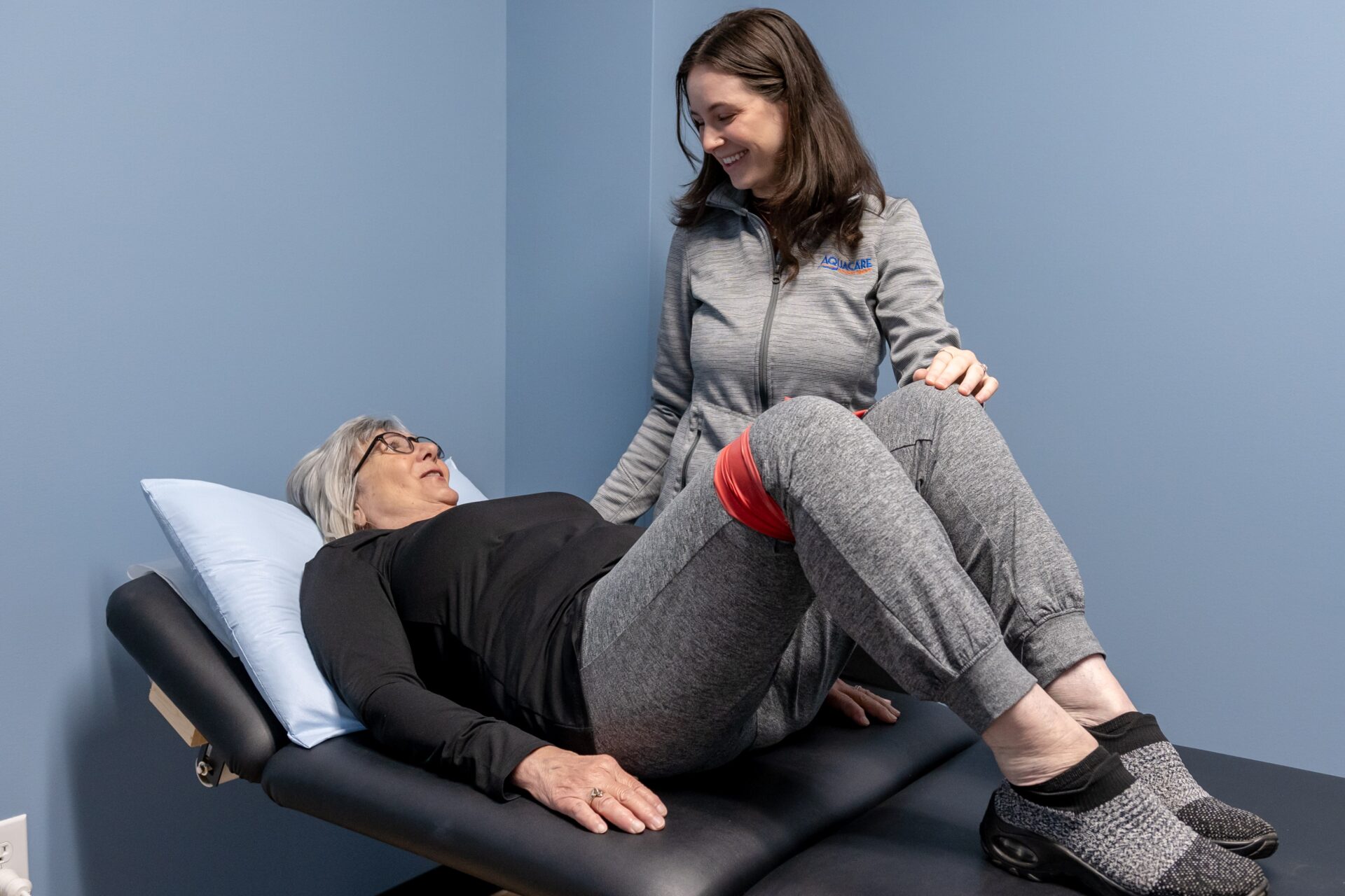 a woman sitting on top of a massage table