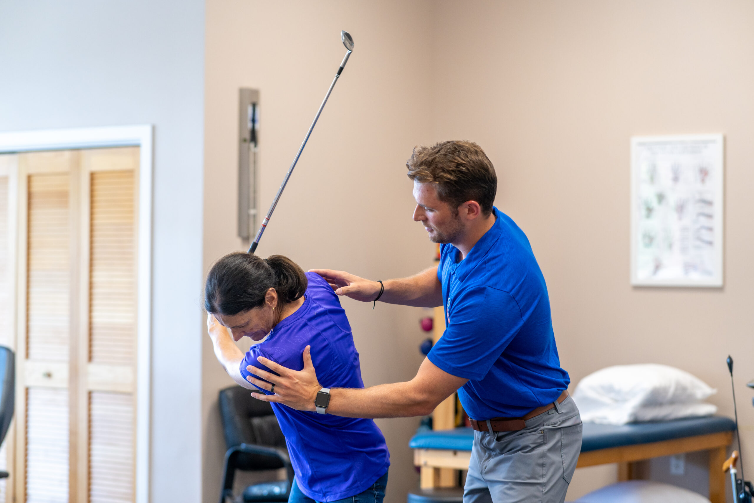 Aquacare physical therapist working with a patient on their golf swing