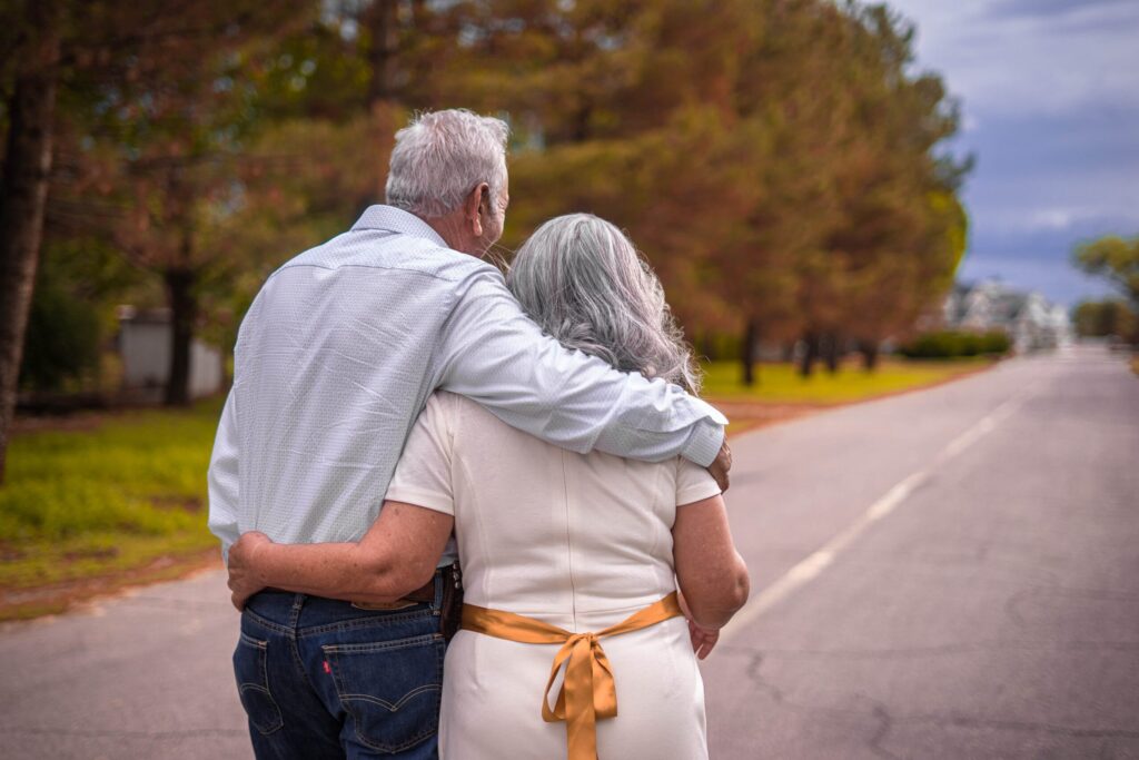 an older couple is walking down the street