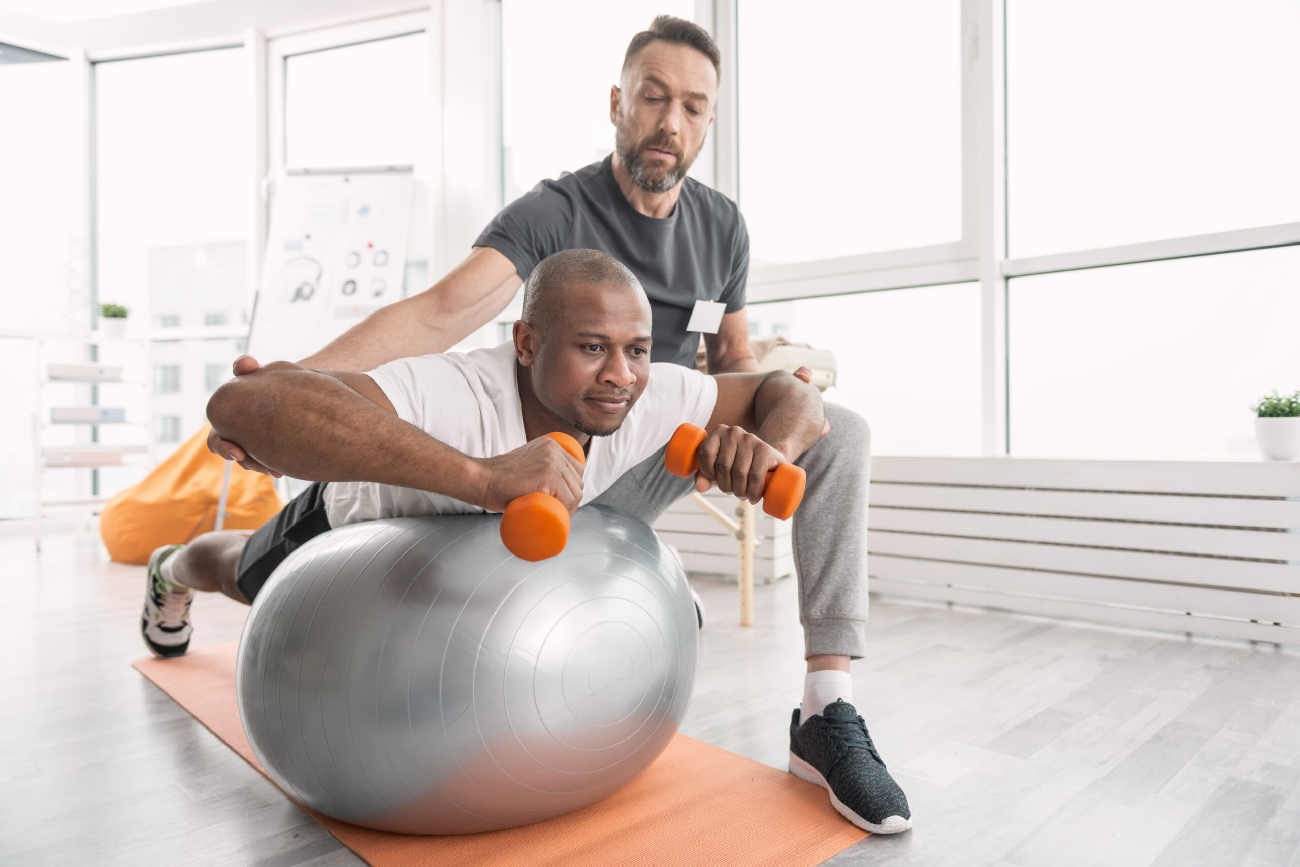 two men are doing exercises on exercise balls