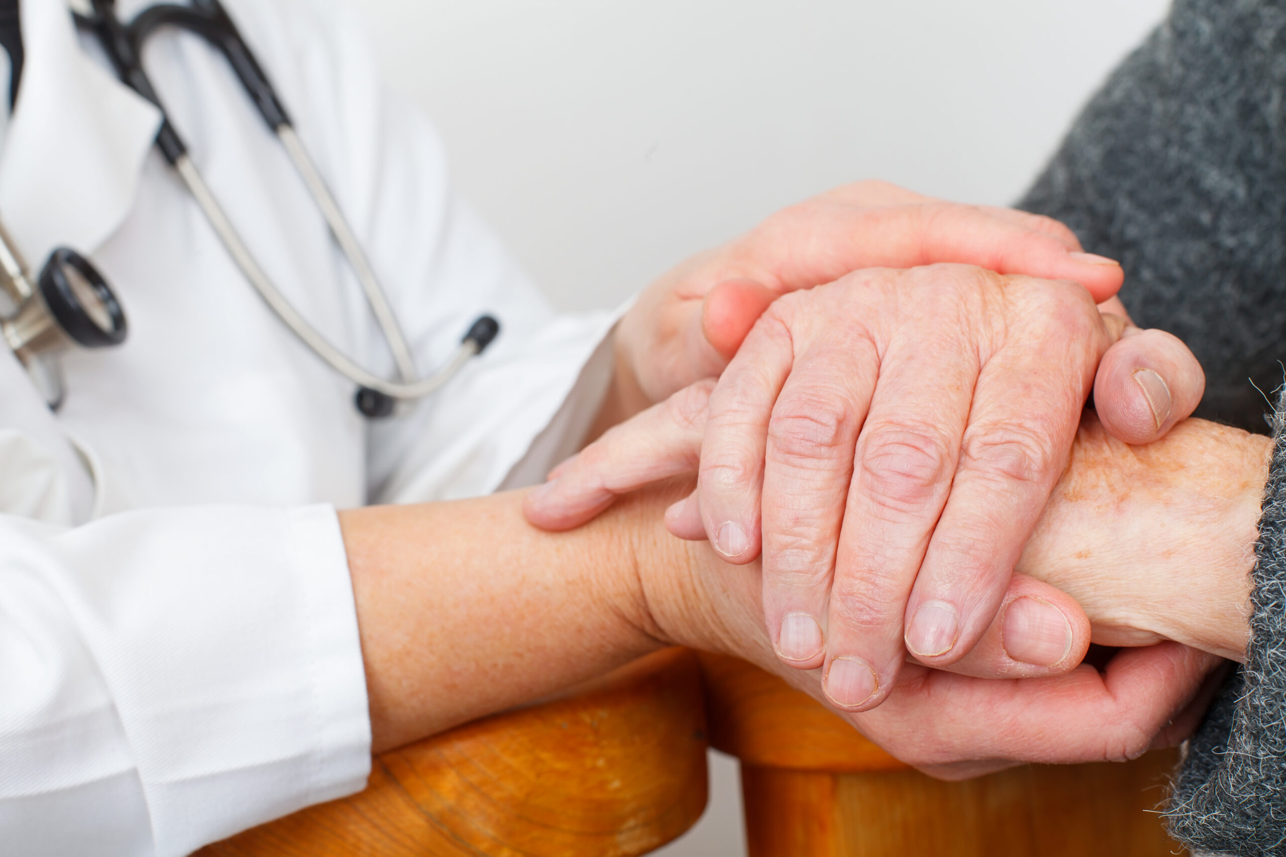 Doctor holding the hand of a patient