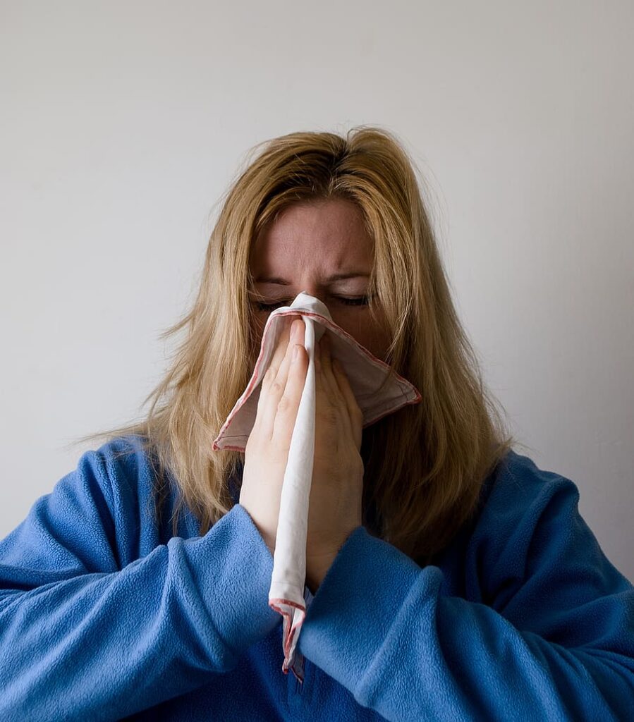 a woman covers her mouth with a napkin