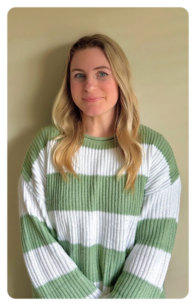 a woman wearing a green and white striped sweater