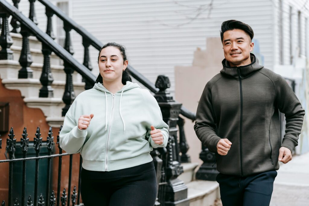 a man and woman jogging down the street