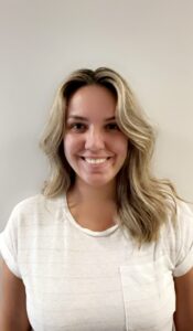 a woman with blonde hair and a white shirt