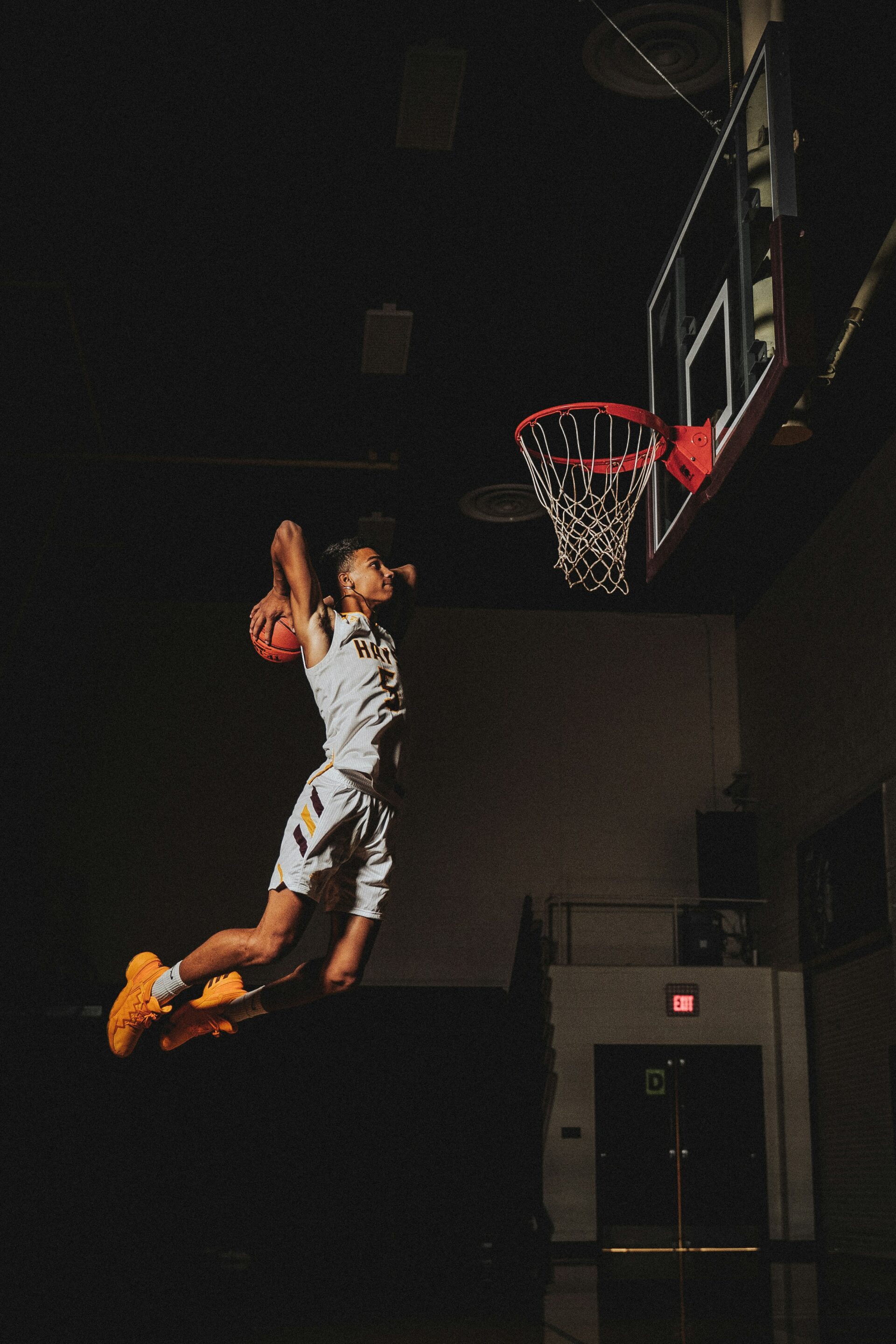 a basketball player jumping in the air to dunk a basketball