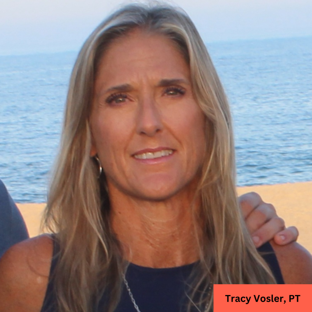 a woman standing on a beach next to the ocean