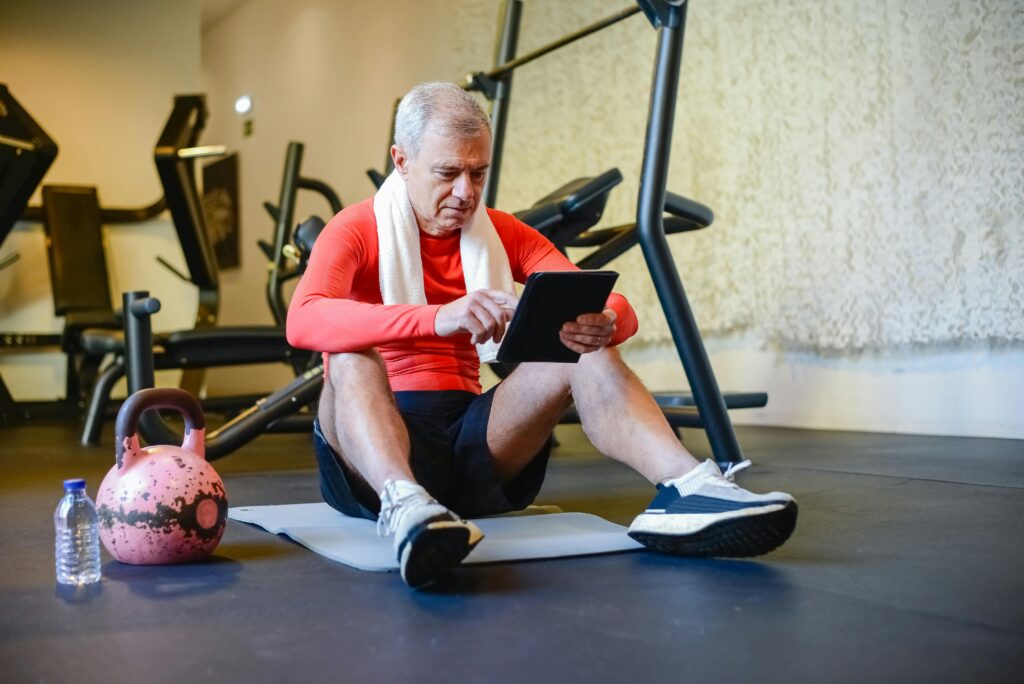 a man sitting on the ground using a tablet