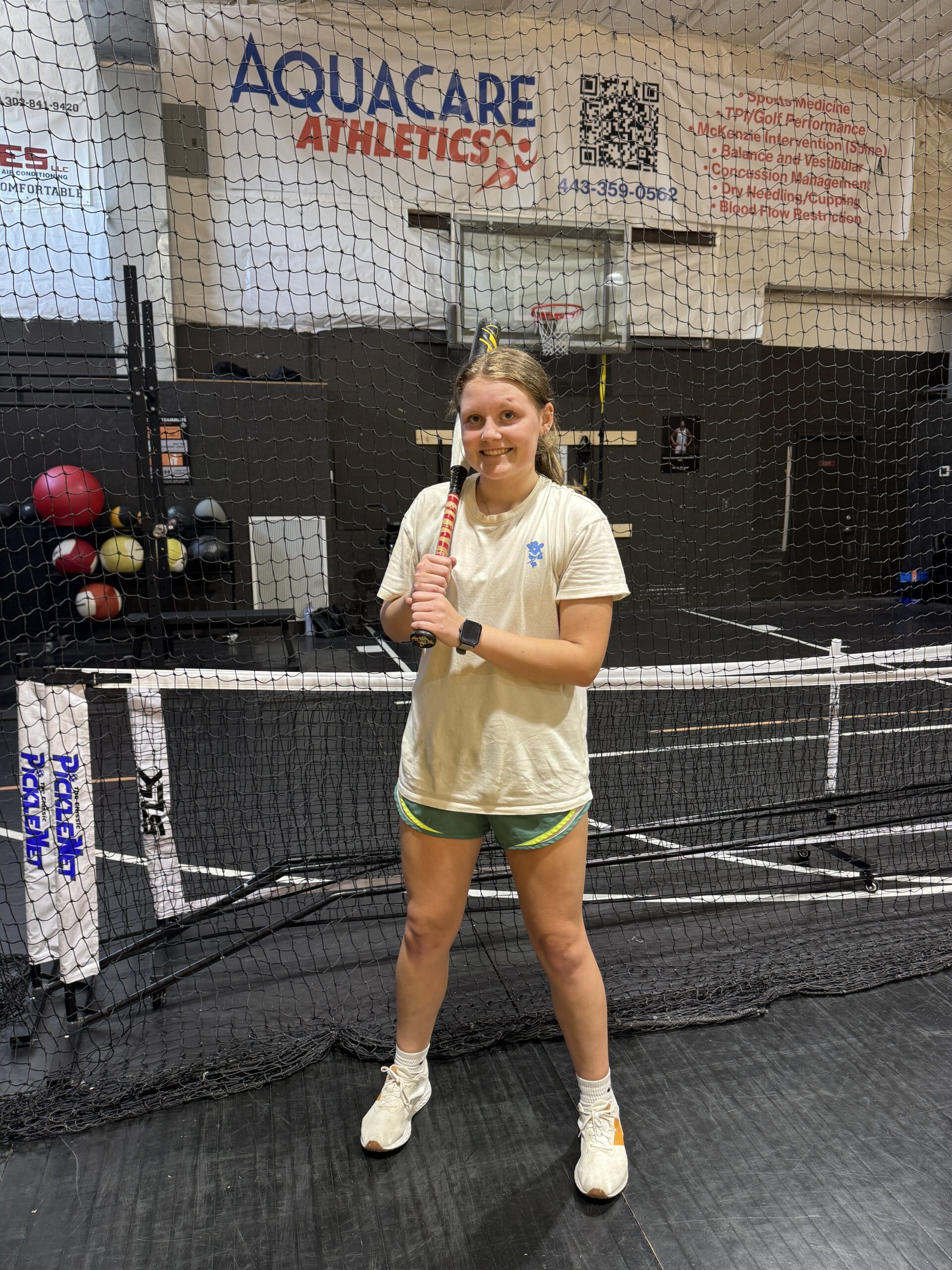 a woman standing on a tennis court holding a racquet