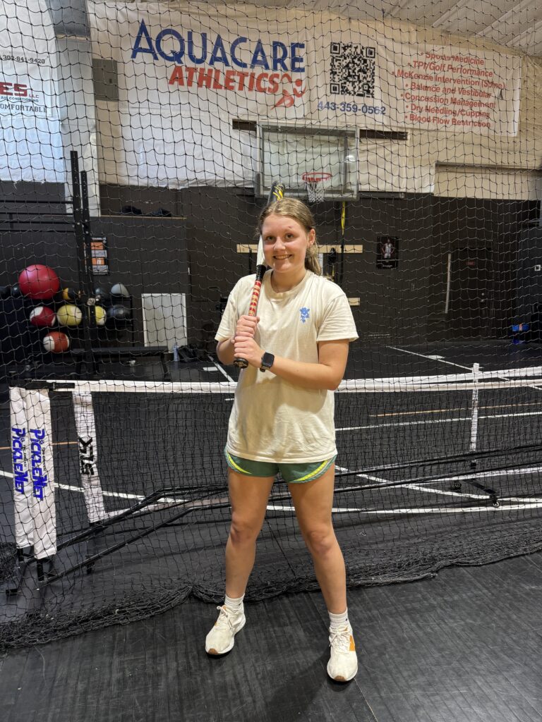 a woman standing on a tennis court holding a racquet